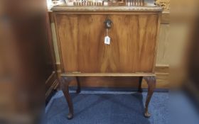 1980's Walnut Record Cabinet, raised on four shaped legs, with pull down front and interior dividers