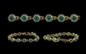 Ladies 14ct Yellow Gold Line Bracelet, set with round blue Topaz well matched and good colour.