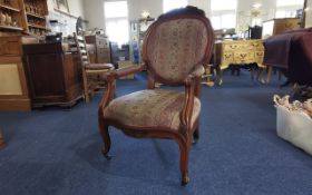 Queen Anne Style Chair, carved wood decoration, two arms, raised on castors, upholstered in