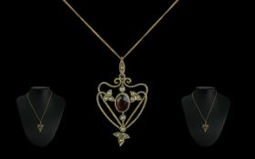 Victorian Art Nouveau Pendant set in 9ct gold with garnets and seed pearls in a lovely design,