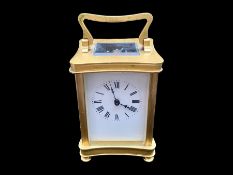 A Small Brass Carriage Clock of typical form, white enamel dial and Roman numerals. Height 4½