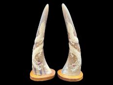 Pair of Buffalo Horns, decorated with carved dragons with stone set eyes. Mounted on wooden bases.