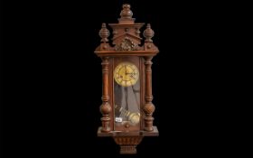 Vienna Wall Clock, working order, decorative columns, and carved finial. Gold colour face with Roman