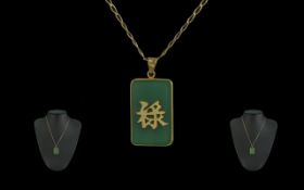9ct Gold Jade Pendant with attached 9ct Gold chain, both marked 9ct. Length 20'' - 50 cm. Weight 7.