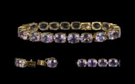 10ct Gold Attractive Amethyst Set Line Bracelet marked 10ct. The well matched Amethysts of good
