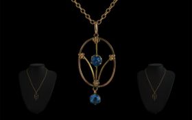 9ct Gold Edwardian Pendant, set with blue stones, suspended on a link chain.