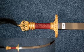 Decorative Oriental Style Fantasy Display Cutlass with dragon handle decorated in gold and red.