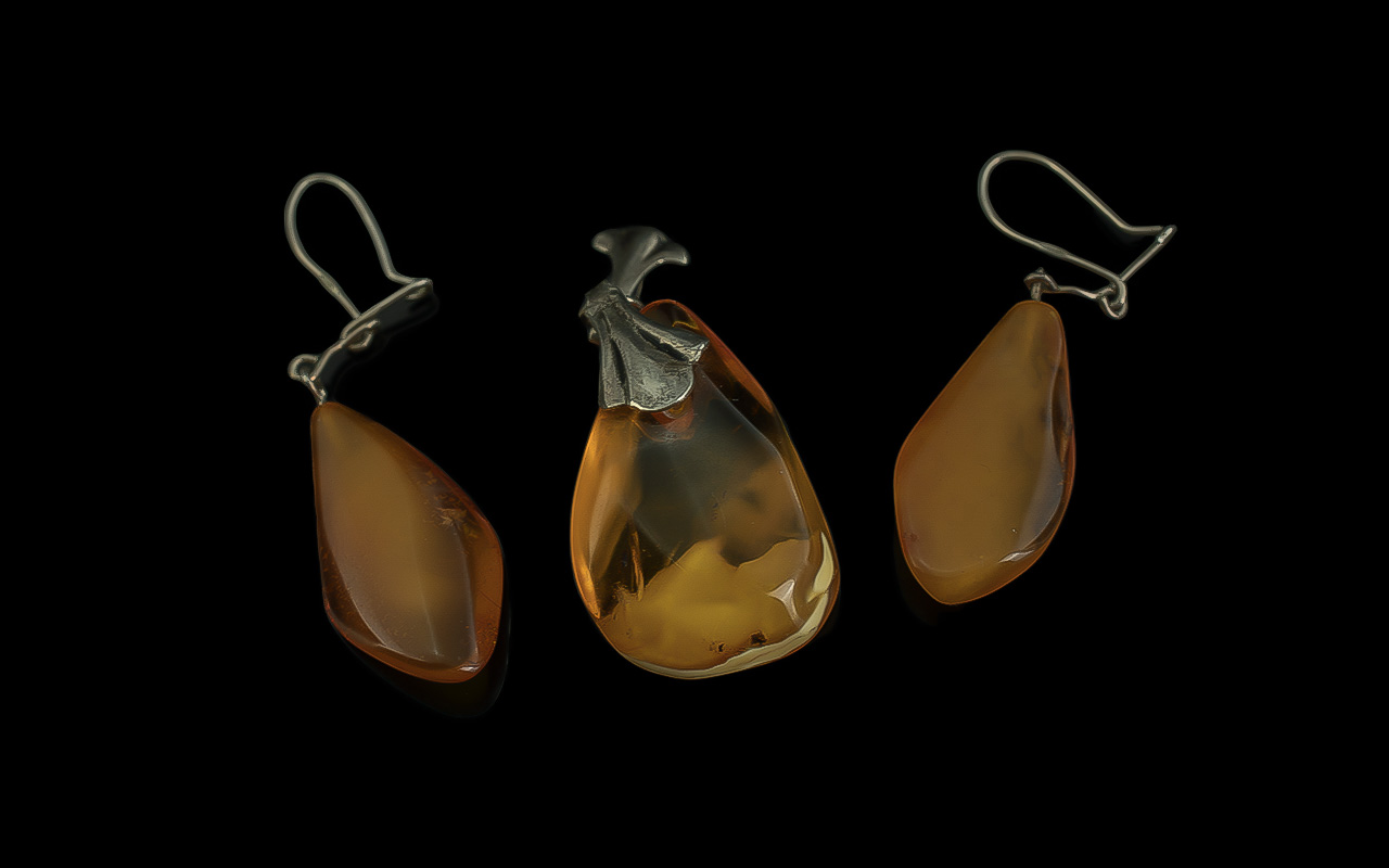 Pair of Butterscotch Amber Drop Earrings plus a similar, amber pear drop shaped pendant; the lozenge