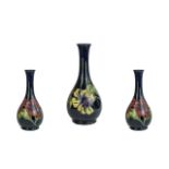 Moorcroft Tall Tube lined Bulbous Vase with Long Stem. ' Hibiscus ' Variation Design on Blue Ground,
