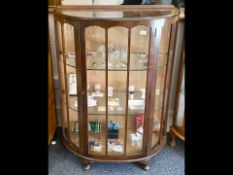 1930's Bow Front Display Cabinet, glass interior shelves, raised on ball feet, measures approx. 34''