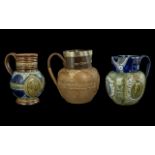 Three Doulton Lambeth Jugs, largest Queen Victoria marked 'She Wrought her People Lasting Good',