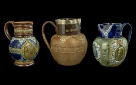 Three Doulton Lambeth Jugs, largest Queen Victoria marked 'She Wrought her People Lasting Good',