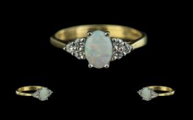 18ct Gold - Petite Opal and Diamond Set Ring of Elegant Form. Full Hallmark for 18ct. The Oval