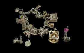 Vintage Silver Charm Bracelet, loaded with 18 charms including bullfighter, policeman's helmet,