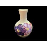 Moorcroft Bud Vase, cream base with pink and purple Clematis pattern, measures 5.5'' tall. Marked