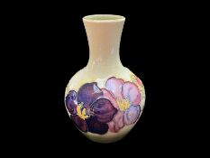 Moorcroft Bud Vase, cream base with pink and purple Clematis pattern, measures 5.5'' tall. Marked