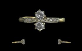 18ct Gold and Platinum Two Stone Diamond Set Ring, With Diamond Set Shoulders. Marked 18ct to