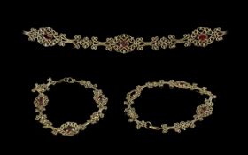 9ct Gold Ruby Set Bracelet, a pretty, ornate, 9ct gold bracelet set with three rubies; 5.2g, 7.25