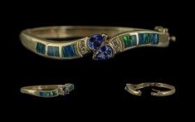 14ct Gold - Excellent Quality Tanzanite and Diamond Set Double Snake Head Hinged Bangle. Marked 14ct