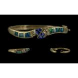 14ct Gold - Excellent Quality Tanzanite and Diamond Set Double Snake Head Hinged Bangle. Marked 14ct