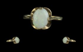 Opal Solitaire Ring, an attractive opal of good colour set in 9ct gold; ring size M, fully