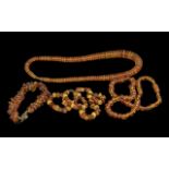 Three Various Baltic Amber Necklaces and One Bracelet, similar, comprising one of honey colour,