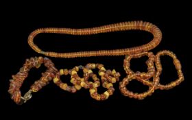 Three Various Baltic Amber Necklaces and One Bracelet, similar, comprising one of honey colour,