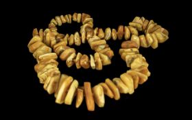 Long Yellow and Butterscotch Amber Necklace, a magnificent necklace of large, graduated nuggets of