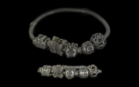 A Pandora Silver Bracelet with three charms.