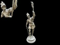 Metal Cast Figure of a Soldier, raised on a circular mount, holding a torch and sword. Measures 16''