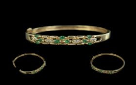 14ct Yellow Gold Attractive Emerald and Diamond Set Hinged Bangle. Marked 585 - 14ct. Emeralds and