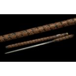 Early 20th Century Sword Stick / Baton with highly carved decoration and brass mount; 21 inches (