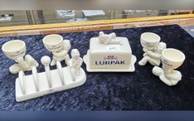 Lurpack Collectibles, comprising butter dish, toast rack, and four assorted egg cups.