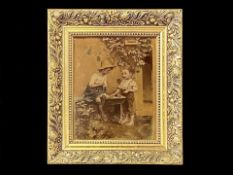 A Crystoleum Picture housed in a later gilt frame. Depicts two children in back yard playing.
