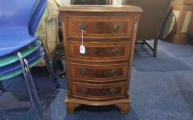 Mahogany Four Drawer Chest, curved bow front, brass handles, raised on four feet.