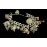 A Superb Vintage Sterling Silver Charm Bracelet - Loaded with 15 Good Quality Silver Charms.