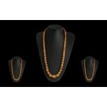 A Superb Quality Early 20th Century Graduated Butterscotch Beaded Necklace of Long Length and