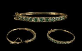 A Good Quality 9ct Gold Emerald and Diamond Set Hinged Bangle. Fully Hallmarked for 9.375.
