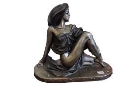 Modern Metal Sculpture of a Lady, in a glamorous pose, measures approx. 16" high x 20" wide.