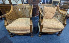 Two Matching Bergere armchairs. Carved wooden arms, claw feet, Canework is in good condition on