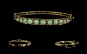 Ladies Attractive Edwardian Period 1902 - 1910 Opal Set Hinged Bangle with Safety Chain. Set with 13