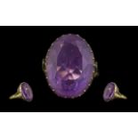 9ct Gold Impressive Single Stone Amethyst Set Dress Ring, marked 9ct to shank. The large oval shaped