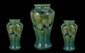 William Moorcroft Signed Tube lined Vase of Wasted Form ' Leaf's and Black Berries Design ' c.