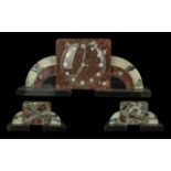 Art Deco Three Piece Garniture Set, of square form, marble with arched stepped supports on a black