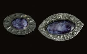 Pair of Arts & Crafts Ruskin Pottery Cabochon Oval Shaped Brooches, mounted in embossed pewter