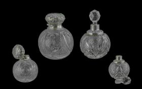 Pair of Edwardian Period Sterling Silver Topped Cut Glass Perfume Bottles, of globular form.