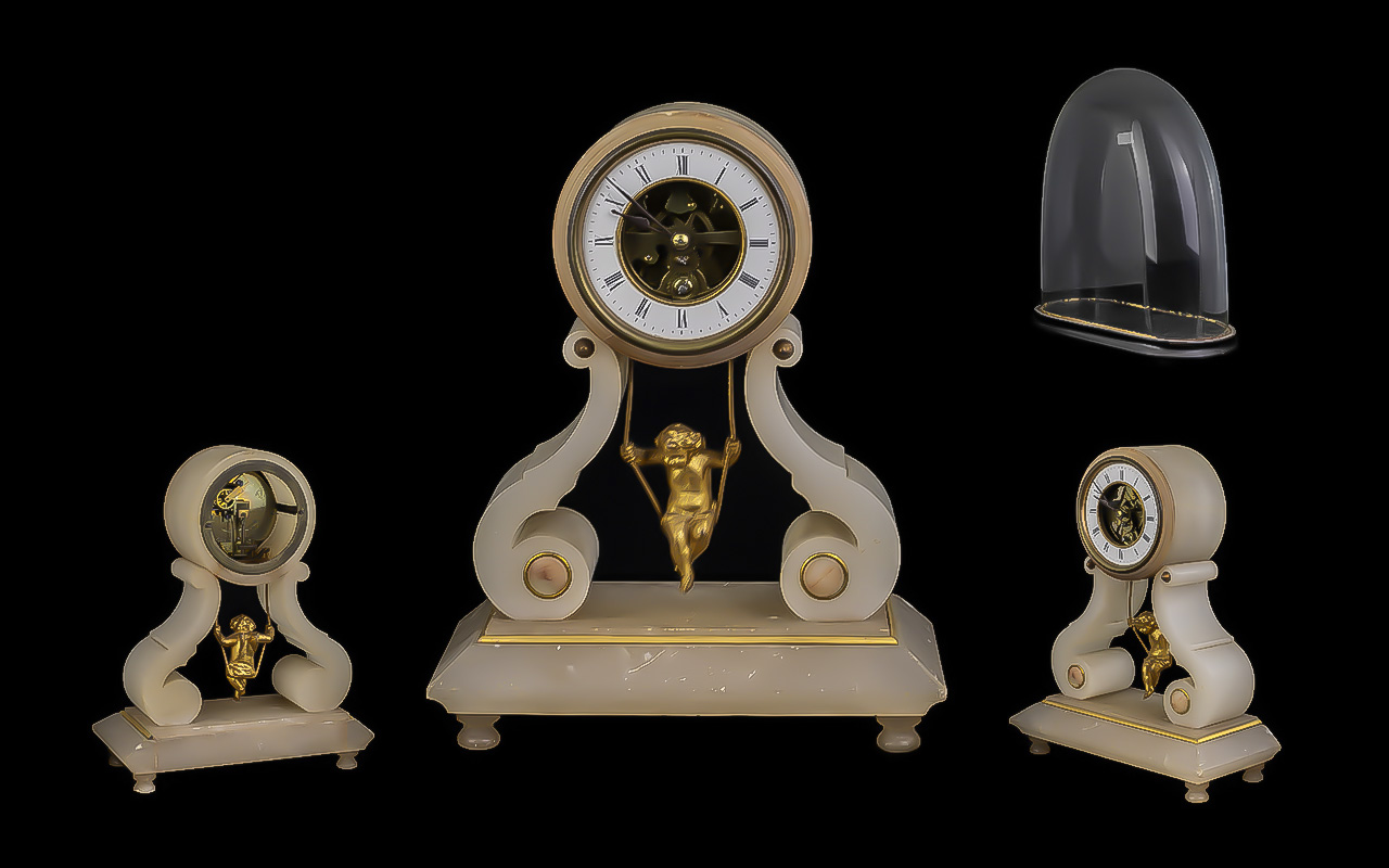 Cream Marble Clock, square base with shaped supports, with a cherub on a swing between.