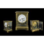 A Brass Framed Mantle Clock, white porcelain dial with Arabic Numerals, spring driven, unmarked.