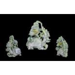 A 20th Century Oriental Carved Jade Sculpture depicting a stylised dragon. Height 4 inches.