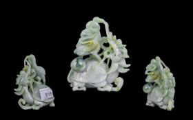 A 20th Century Oriental Carved Jade Sculpture depicting a stylised dragon. Height 4 inches.